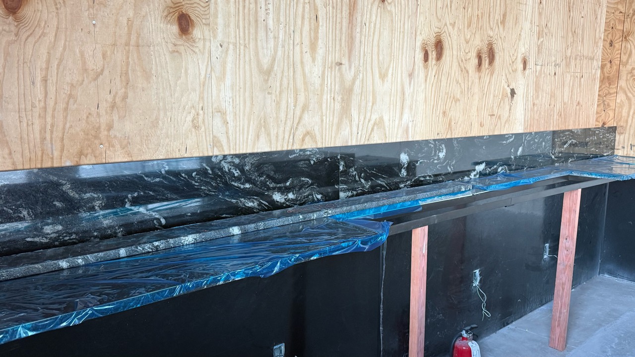 Installed stone back countertop and matching backsplash at Libations