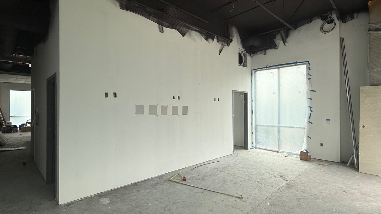 Updated construction photo showing more back room progress and interior wall work