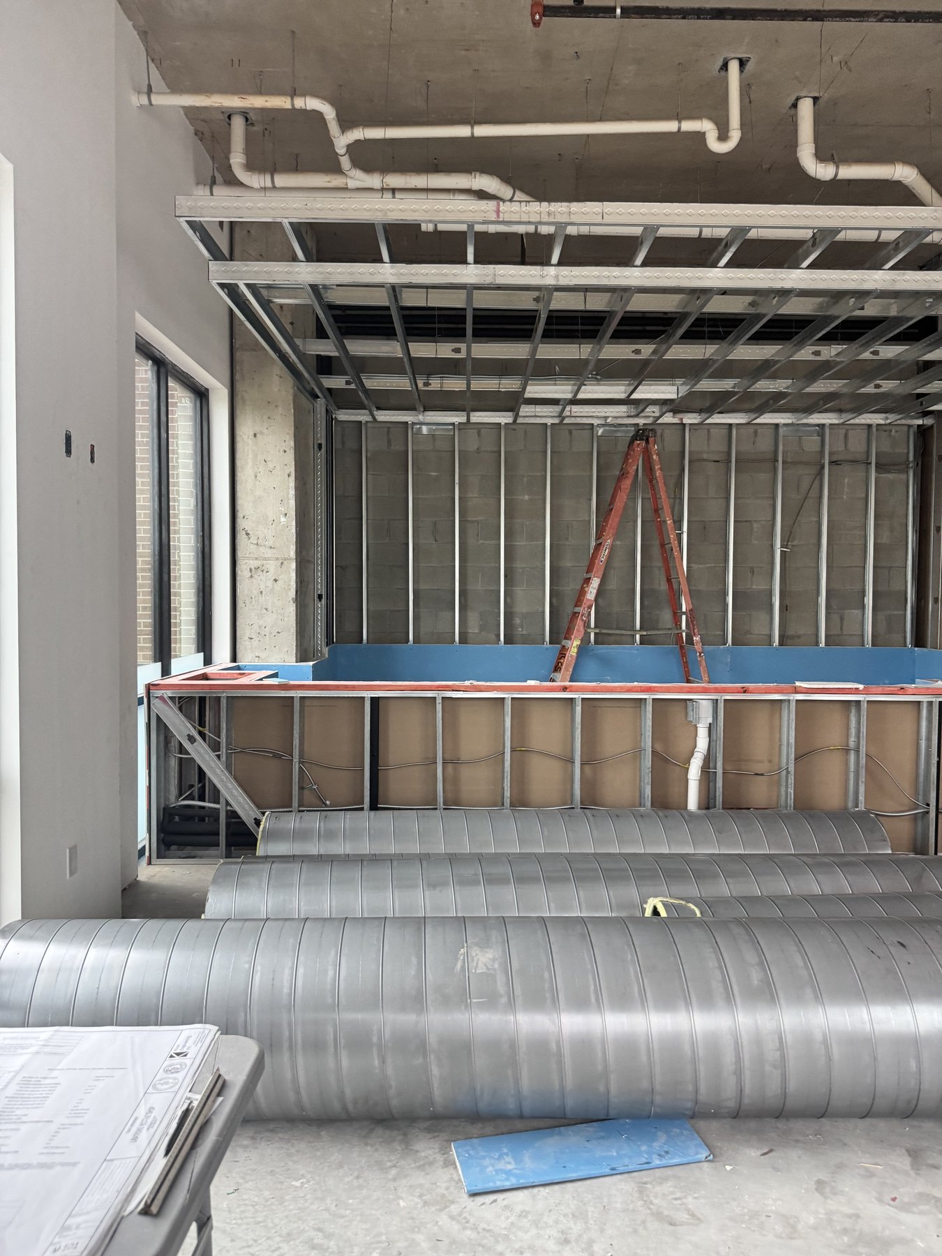 Updated construction photo of blue counter framing and ceiling work